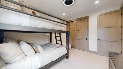 a bedroom with two bunk beds with a ladder at Winter Park Condo w/Hot Tub & 4 Mi to Skiing in Winter Park