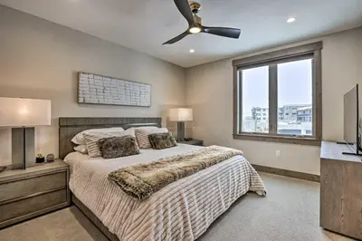 a bedroom with a bed and a ceiling fan at Winter Park Condo w/Hot Tub & 4 Mi to Skiing in Winter Park
