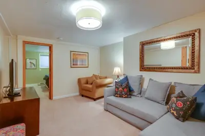 a living room with a couch and a mirror at Hot Tub Family Gem 3 Mi to Frisco Nordic Center in Frisco