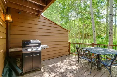 a patio with a grill and a table on a deck at Hot Tub Family Gem 3 Mi to Frisco Nordic Center in Frisco