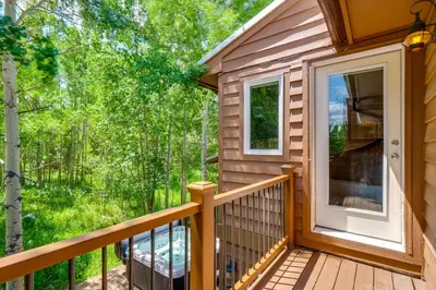 a cabin with a balcony with a door at Hot Tub Family Gem 3 Mi to Frisco Nordic Center in Frisco