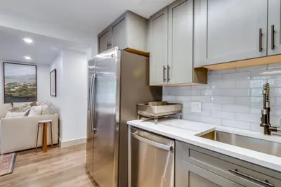 a kitchen with white cabinets and a stainless steel refrigerator at Hot Tub Family Gem 3 Mi to Frisco Nordic Center in Frisco