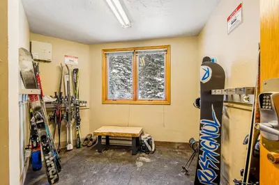 a room with skis and a bench in a room with a window at Iron Horse Resort D3084 in Winter Park