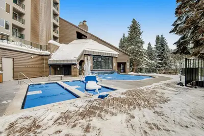 a swimming pool with a blue chair in the sand at Iron Horse Resort D3084 in Winter Park