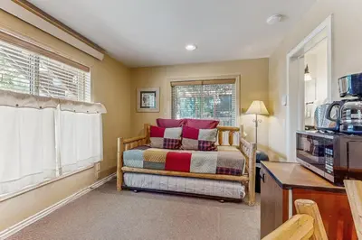 a bedroom with a bed and a window at On the Rapids - A Unit in Grand Lake