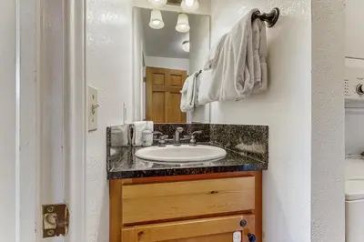 a bathroom with a sink and a mirror at On the Rapids - A Unit in Grand Lake