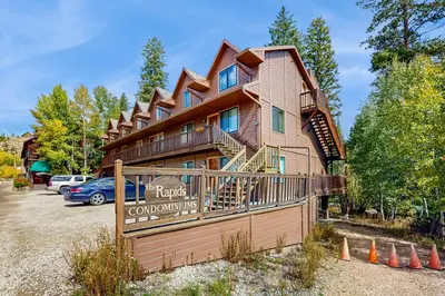 a large building with a sign in front of it at On the Rapids - A Unit in Grand Lake