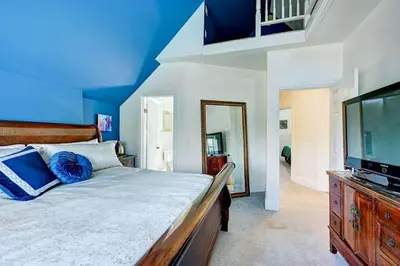 a bedroom with a bed and a flat screen tv at Victorian Manor 1 mile from Downtown Denver! in Denver