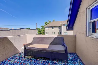 a chair sitting on the back of a balcony at Victorian Manor 1 mile from Downtown Denver! in Denver