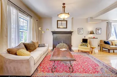 a living room with a couch and a fireplace at Victorian Manor 1 mile from Downtown Denver! in Denver
