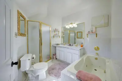 a bathroom with a tub and a toilet and a sink at Victorian Manor 1 mile from Downtown Denver! in Denver