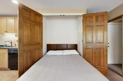a small bedroom with a bed in a kitchen at On the Rapids - B Unit in Grand Lake