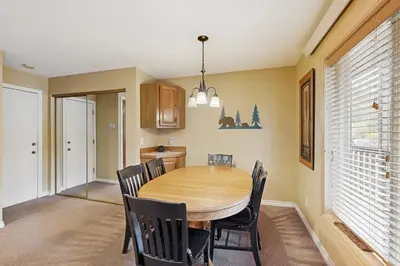 a dining room with a wooden table and chairs at On the Rapids - B Unit in Grand Lake