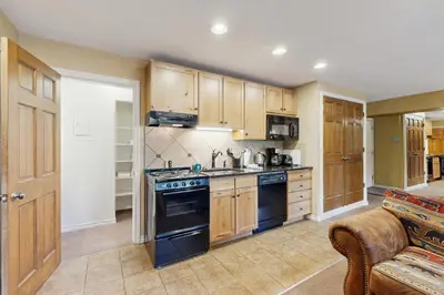 a kitchen with wooden cabinets and a stove top oven at On the Rapids - B Unit in Grand Lake