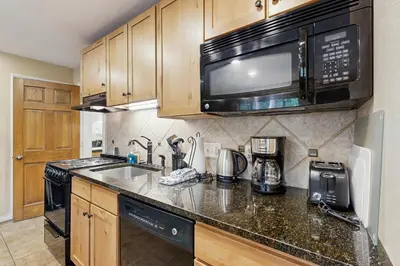 a kitchen with a sink and a microwave at On the Rapids - B Unit in Grand Lake