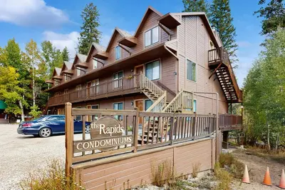 a building with a sign that reads the rails colonial inn at On the Rapids - B Unit in Grand Lake