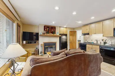 a living room with a couch and a kitchen at On the Rapids - B Unit in Grand Lake