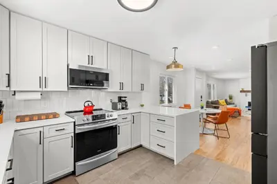 a kitchen with white cabinets and a stove top oven at 6224 S Datura St in Littleton