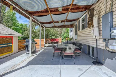 a patio with a table and chairs and a grill at 6224 S Datura St in Littleton