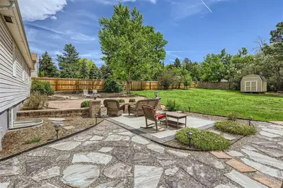 a patio with a table and chairs in a yard at 6224 S Datura St in Littleton