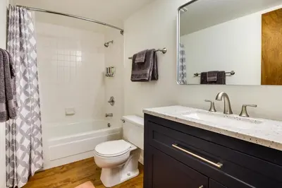 a bathroom with a sink and a toilet and a mirror at Fraser Condo Rental with Balcony, Mountain Views! in Fraser