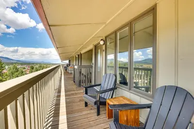a balcony with two chairs and a table on it at Fraser Condo Rental with Balcony, Mountain Views! in Fraser