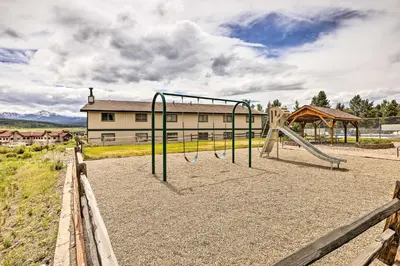 a playground with a slide in front of a building at Fraser Condo Rental with Balcony, Mountain Views! in Fraser