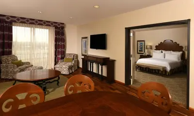 a hotel room with a bed and a living room at Woolley's Classic Suites in Aurora