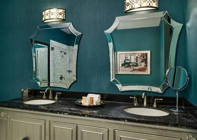 a bathroom with two sinks and two mirrors at Woolley's Classic Suites in Aurora