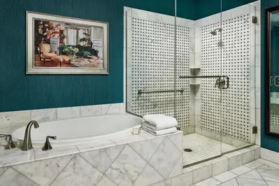 a bathroom with a bath tub and a shower at Woolley's Classic Suites in Aurora