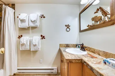 a bathroom with a sink and a mirror at Keystone Condo on Shuttle Line Less Than 1 Mi to Resort! in Dillon