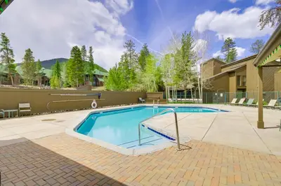 a large swimming pool in a yard with a house at Keystone Condo on Shuttle Line Less Than 1 Mi to Resort! in Dillon