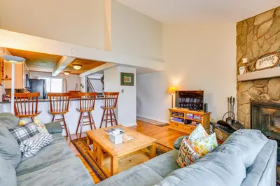 a living room with a couch and a table at Family-Friendly Fraser Condo with Heated Pool Access in Fraser