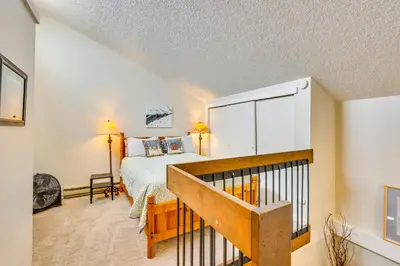 a bedroom with a bed and a staircase in a room at Family-Friendly Fraser Condo with Heated Pool Access in Fraser