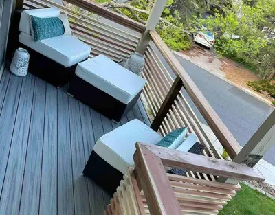 a deck with two chairs and two ottomans at Modern Studio Basement with Private Entrance in Centennial