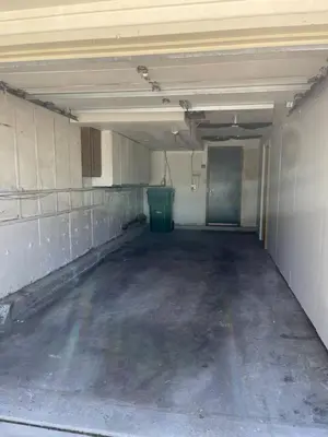 an empty parking garage with a green door in it at Modern Studio Basement with Private Entrance in Centennial