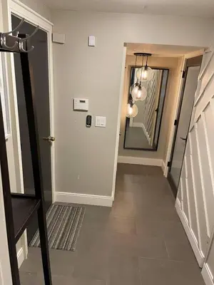 a hallway with a door and a mirror in a house at Modern Studio Basement with Private Entrance in Centennial
