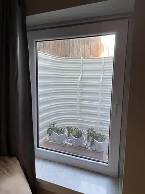 a window with potted plants on a window sill at Modern Studio Basement with Private Entrance in Centennial