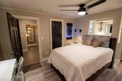 a bedroom with a bed and a ceiling fan at Modern Studio Basement with Private Entrance in Centennial