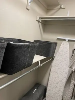 a walk in closet with two baskets and a tie at Modern Studio Basement with Private Entrance in Centennial