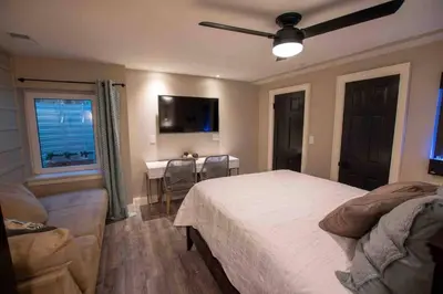 a bedroom with a bed and a couch and a window at Modern Studio Basement with Private Entrance in Centennial