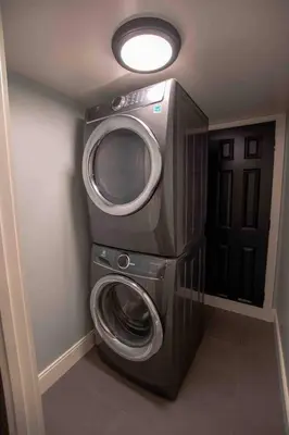 a washing machine in the corner of a room at Modern Studio Basement with Private Entrance in Centennial