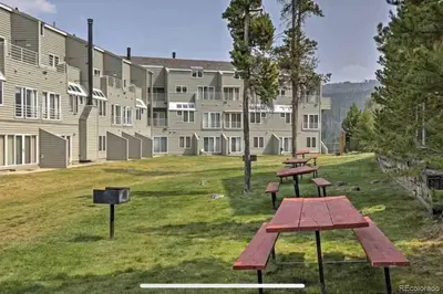 a group of picnic tables in front of a building at Guest Suite Downtown Winter Park GREAT LOCATION in Winter Park