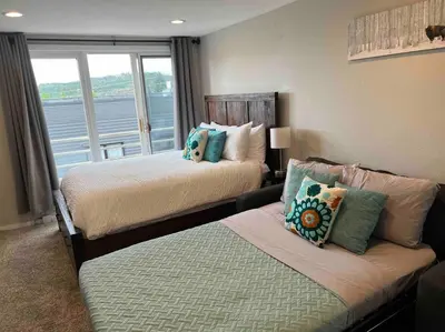 a hotel room with two beds and a window at Guest Suite Downtown Winter Park GREAT LOCATION in Winter Park