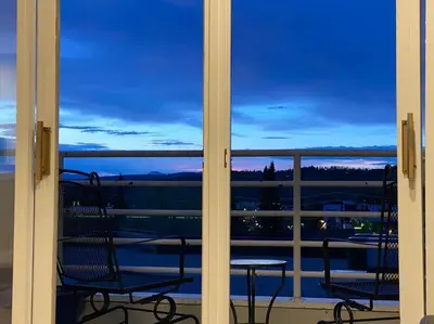 a view from a window of a balcony with two chairs at Great Location! Downtown WP with Hot Tub! Sleeps 6! in Winter Park