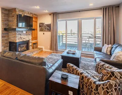 a living room with couches and a fireplace at Great Location! Downtown WP with Hot Tub! Sleeps 6! in Winter Park