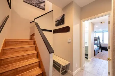 a staircase in a home with wooden steps at Great Location! Downtown WP with Hot Tub! Sleeps 6! in Winter Park