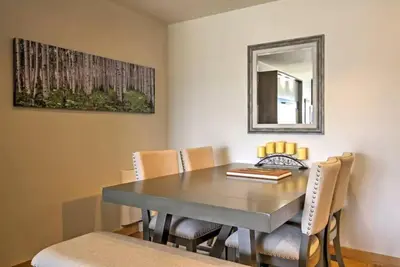 a dining room table with chairs and a mirror at Great Location! Downtown WP with Hot Tub! Sleeps 6! in Winter Park