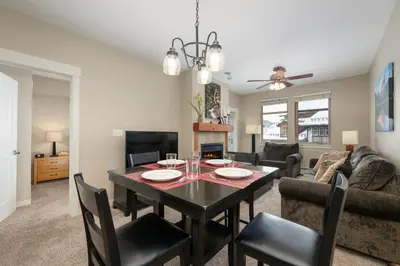 a dining room and living room with a table and chairs at Ski-In / Ski-Out 1 Bedroom Condo base of WP Resort in Winter Park