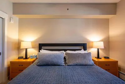 a bedroom with a blue bed with two lamps at Ski-In / Ski-Out 1 Bedroom Condo base of WP Resort in Winter Park